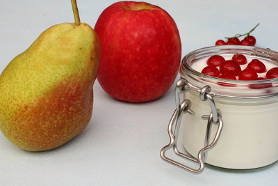 Close-up of apples in glass jar on table