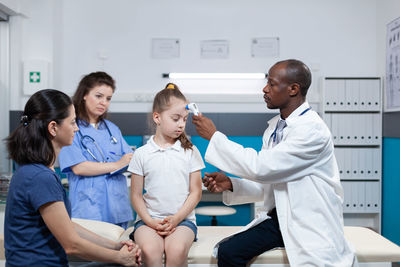 Female doctor examining patient in hospital