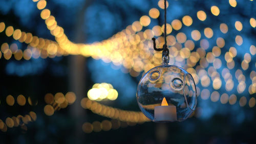 Beautiful evening garden party glass ornaments with candle bokeh of festive light background