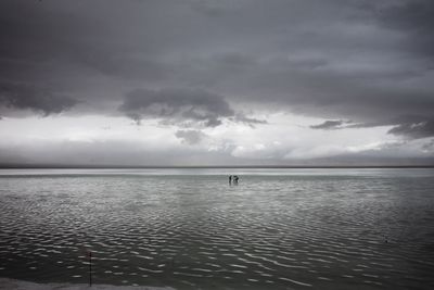 Scenic view of sea against storm clouds