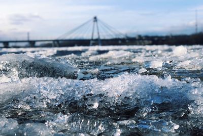 Frozen sea against sky during winter