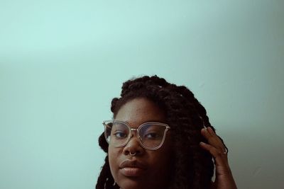 Portrait of young woman over gray background