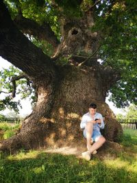 Couple sitting on tree trunk