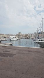 View of harbor against cloudy sky