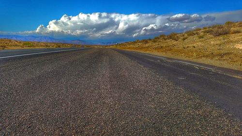 Surface level of empty road against sky