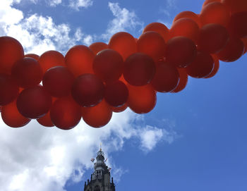 Low angle view of balloons against sky