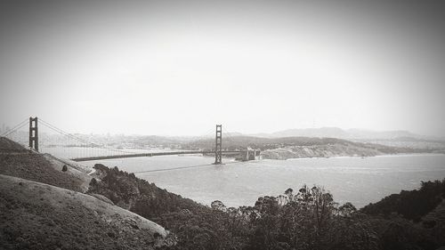 Scenic view of bridge over river against clear sky