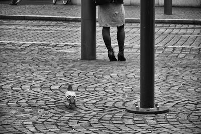 Woman standing on footpath