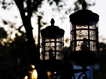 Low angle view of silhouette lantern against sky