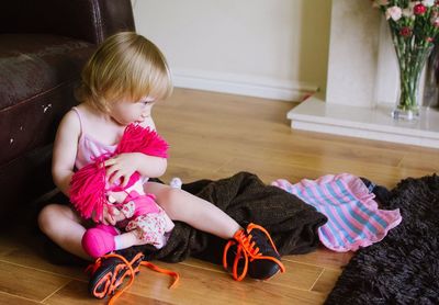 Girl sitting on hardwood floor