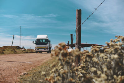 Car on field against sky