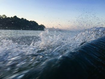 Scenic view of sea against clear sky during sunset