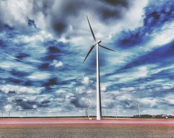 Low angle view of wind turbine against sky