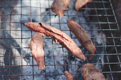 High angle view of meat on barbecue grill