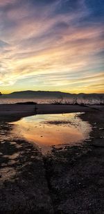 Scenic view of beach against sky during sunset