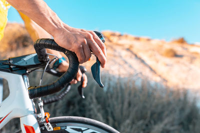 Cropped hands of man holding handlebar