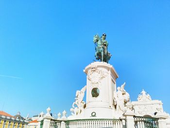 Low angle view of statue against blue sky