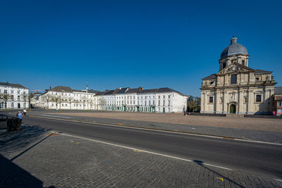 Deserted marketplace in city against blue sky