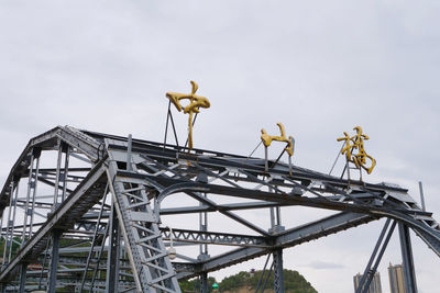 Low angle view of rollercoaster against sky