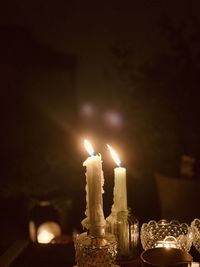 Close-up of illuminated candles on table