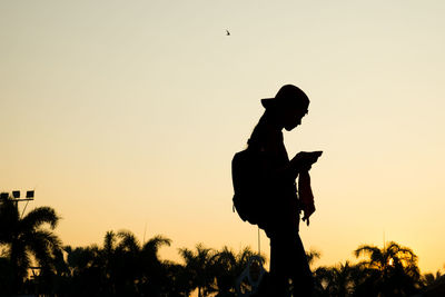 Low angle view of silhouette man against clear sky during sunset