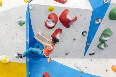 Woman climbing on wall