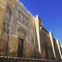 Low angle view of historical building against blue sky