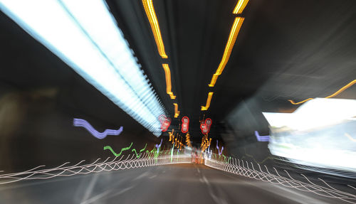Illuminated bridge in city at night