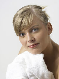 Close-up portrait of woman against white background