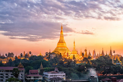 Temple building against sky during sunset