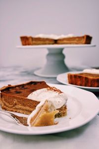 Slice of pumpkin pie served in plate on table