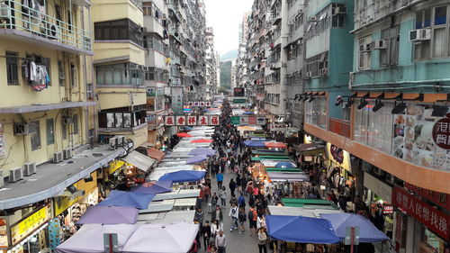 High angle view of vehicles on road along buildings