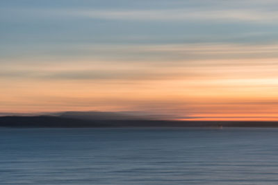 Scenic view of sea against romantic sky at sunset