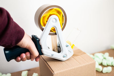 Midsection of man holding paper in box