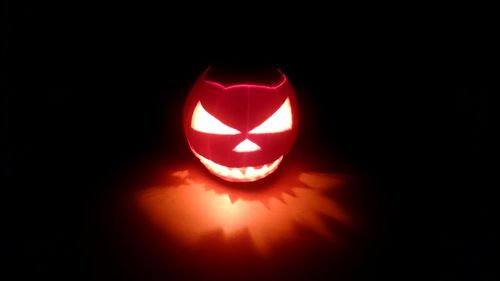 Close-up of illuminated pumpkin against black background