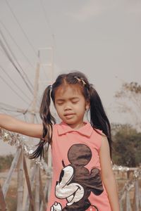 Portrait of cute girl standing outdoors