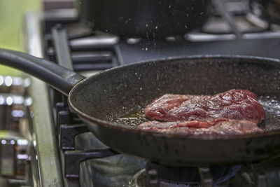 Close-up of meat in cooking pan