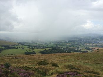 Scenic view of landscape against cloudy sky