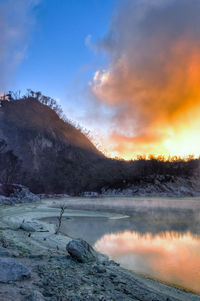 Scenic view of lake against sky during sunset