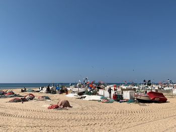 Scenic view of beach against clear blue sky