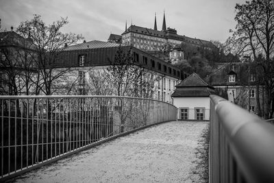 Footbridge leading towards buildings in city