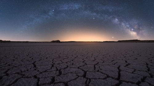 Scenic view of landscape against sky at night