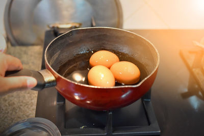 Cropped image of person preparing food in kitchen