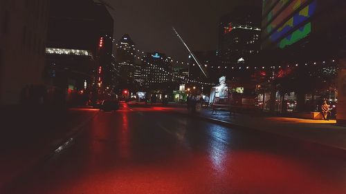 Illuminated city street at night
