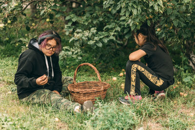 Asian girls embrace fall's charm with apple-picking fun in the garden