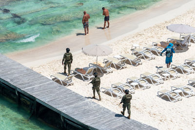 High angle view of people walking on beach