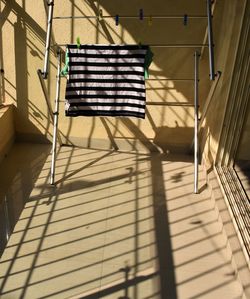 Low angle view of empty chairs against wall