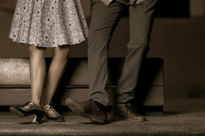 Low section of friends standing on floor