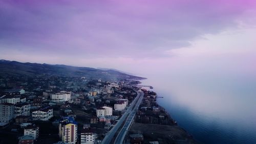 High angle view of buildings and sea against sky