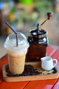 Close-up of coffee by grinder on table